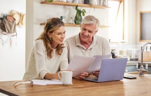 Retirement, finance and couple with budget on laptop satisfied with home expenses in New Zealand. H